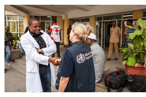 WHO staff and doctor shaking hands