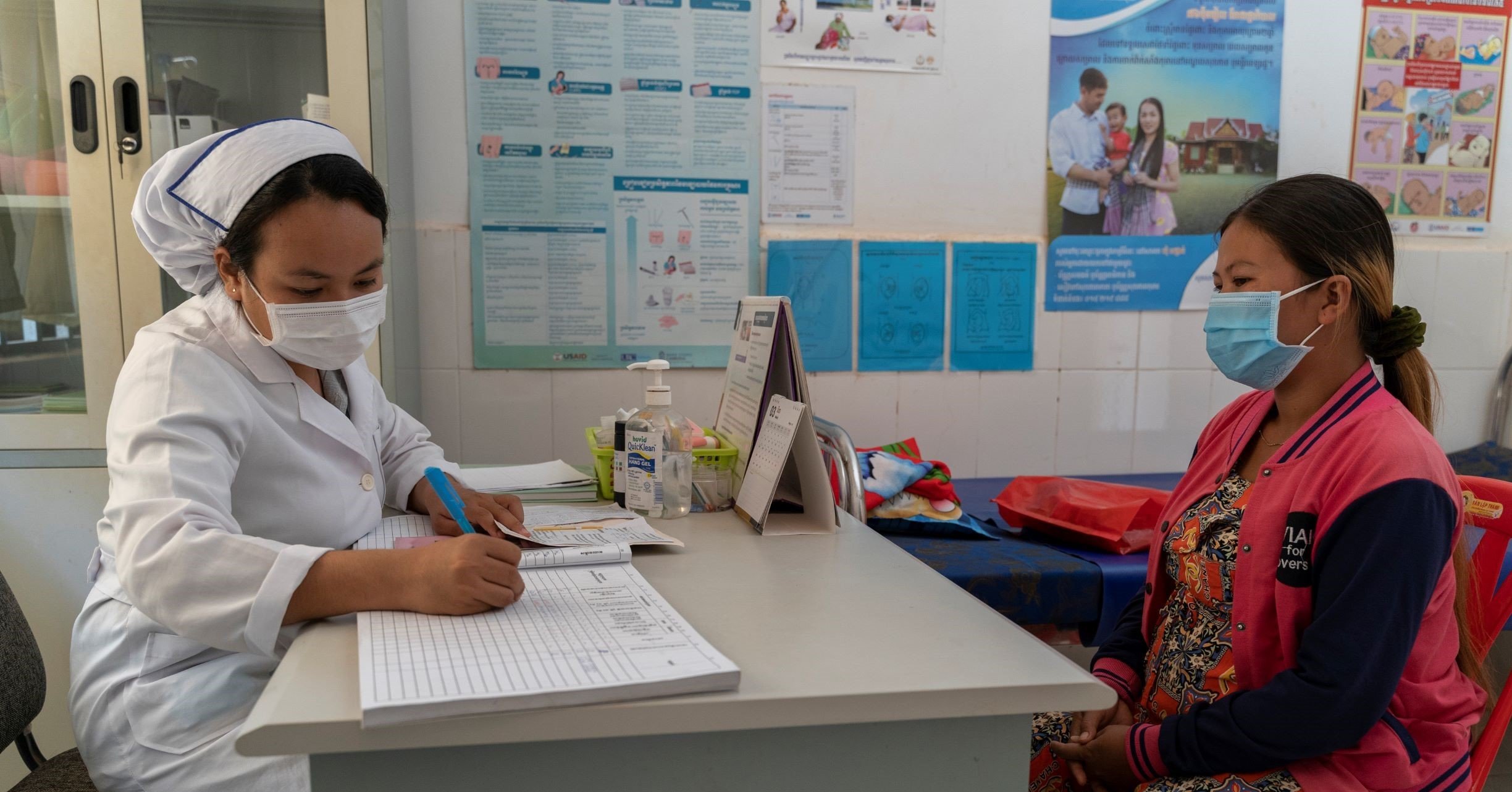 A health-carte worker conducts an antenatal check-up in a health-care centre in Cambodia